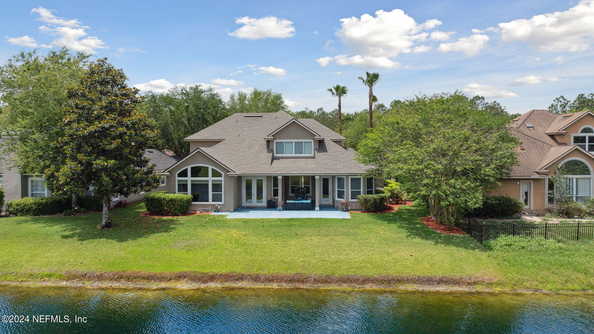 1403 Eagle Crossing Drive Orange Park, FL 32065 - Photo 36 of 71 a front view of a house with a garden and lake view
