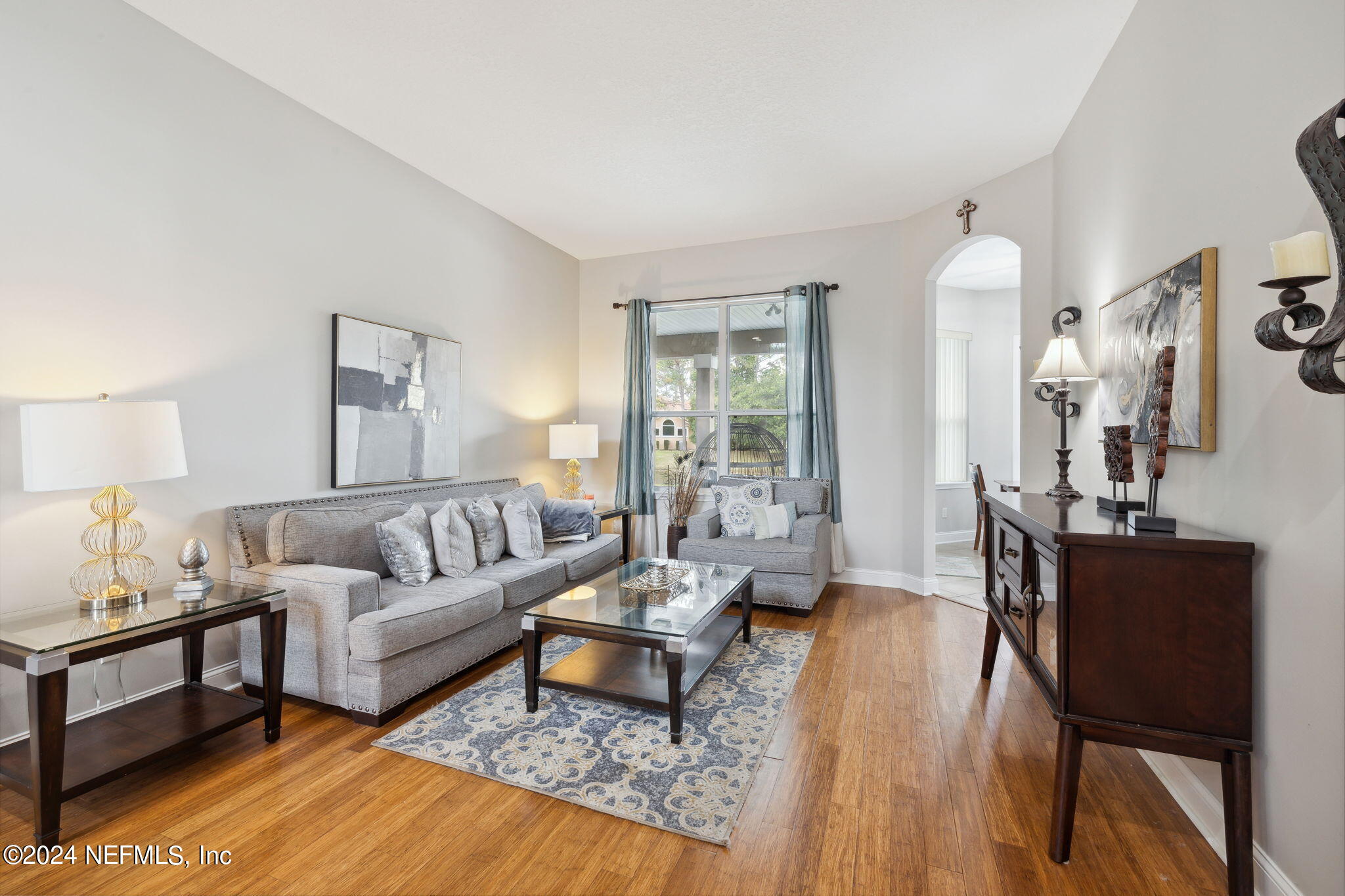 1403 Eagle Crossing Drive Orange Park, FL 32065 - Photo 5 of 71 a living room with furniture wooden floor and a lamp