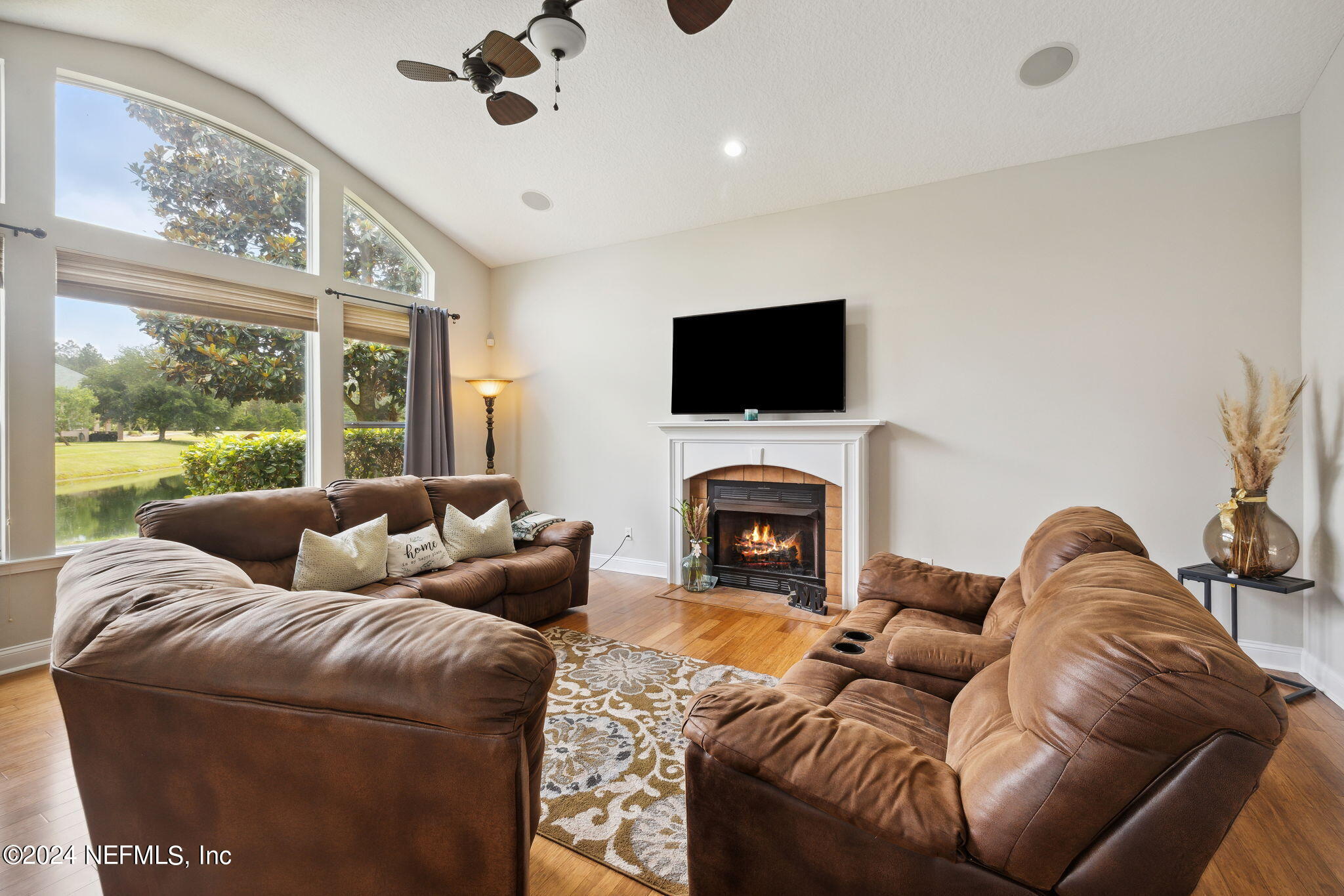 1403 Eagle Crossing Drive Orange Park, FL 32065 - Photo 7 of 71 a living room with furniture a fireplace and a flat screen tv