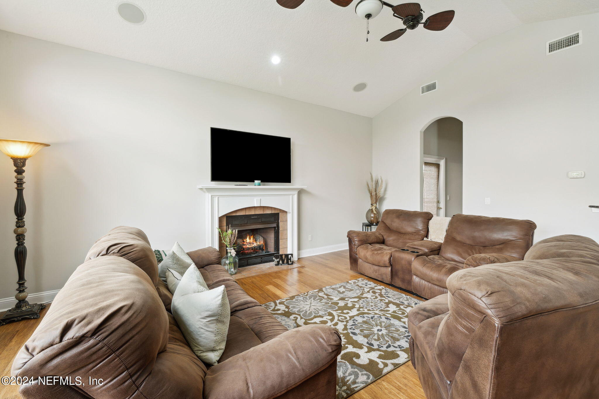 1403 Eagle Crossing Drive Orange Park, FL 32065 - Photo 8 of 71 a living room with furniture a flat screen tv and a fireplace