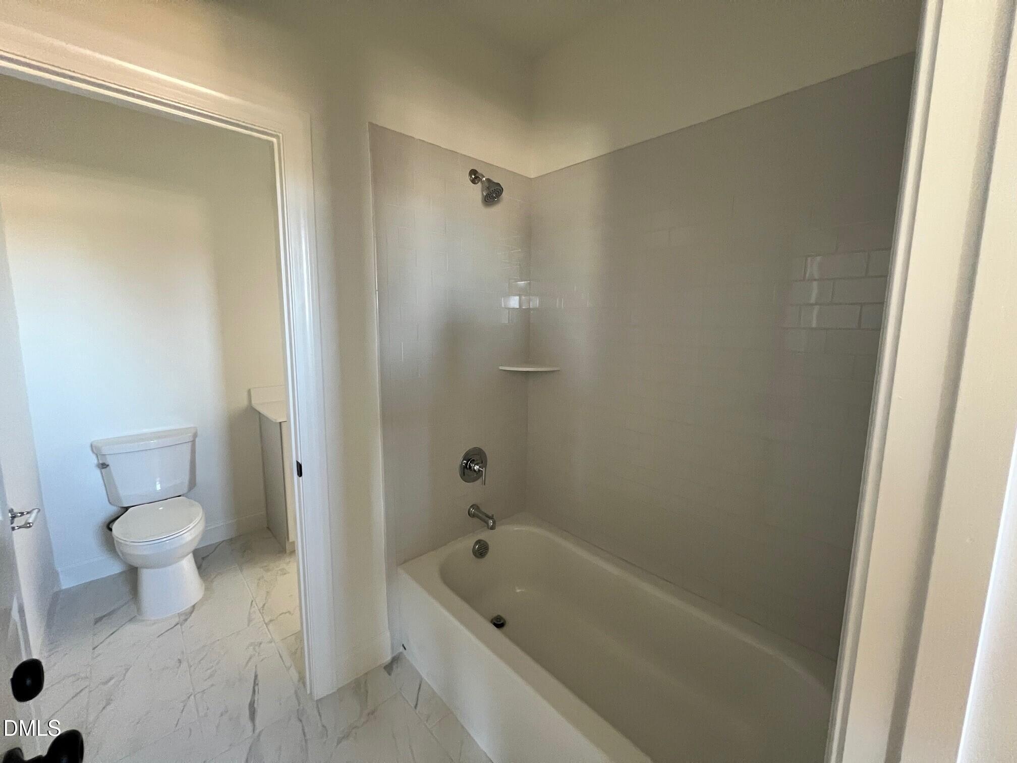1005 Coldspring Circle Durham, NC 27705 - Photo 15 of 21 a bathroom with a bathtub and a toilet
