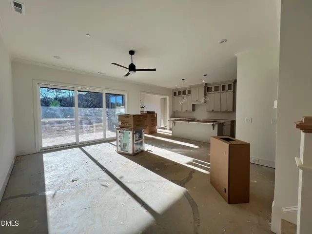 a large kitchen with stainless steel appliances kitchen island granite countertop a refrigerator and a stove top oven