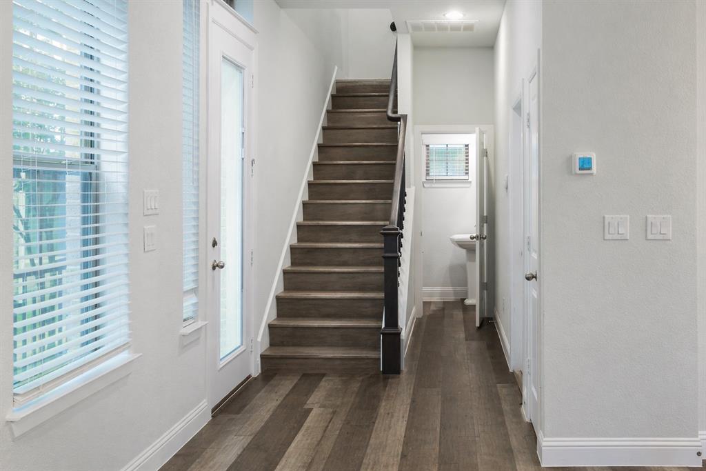 1115 Manacor Lane Dallas, TX 75212 - Photo 18 of 28 a view of a hallway with stairs and a window