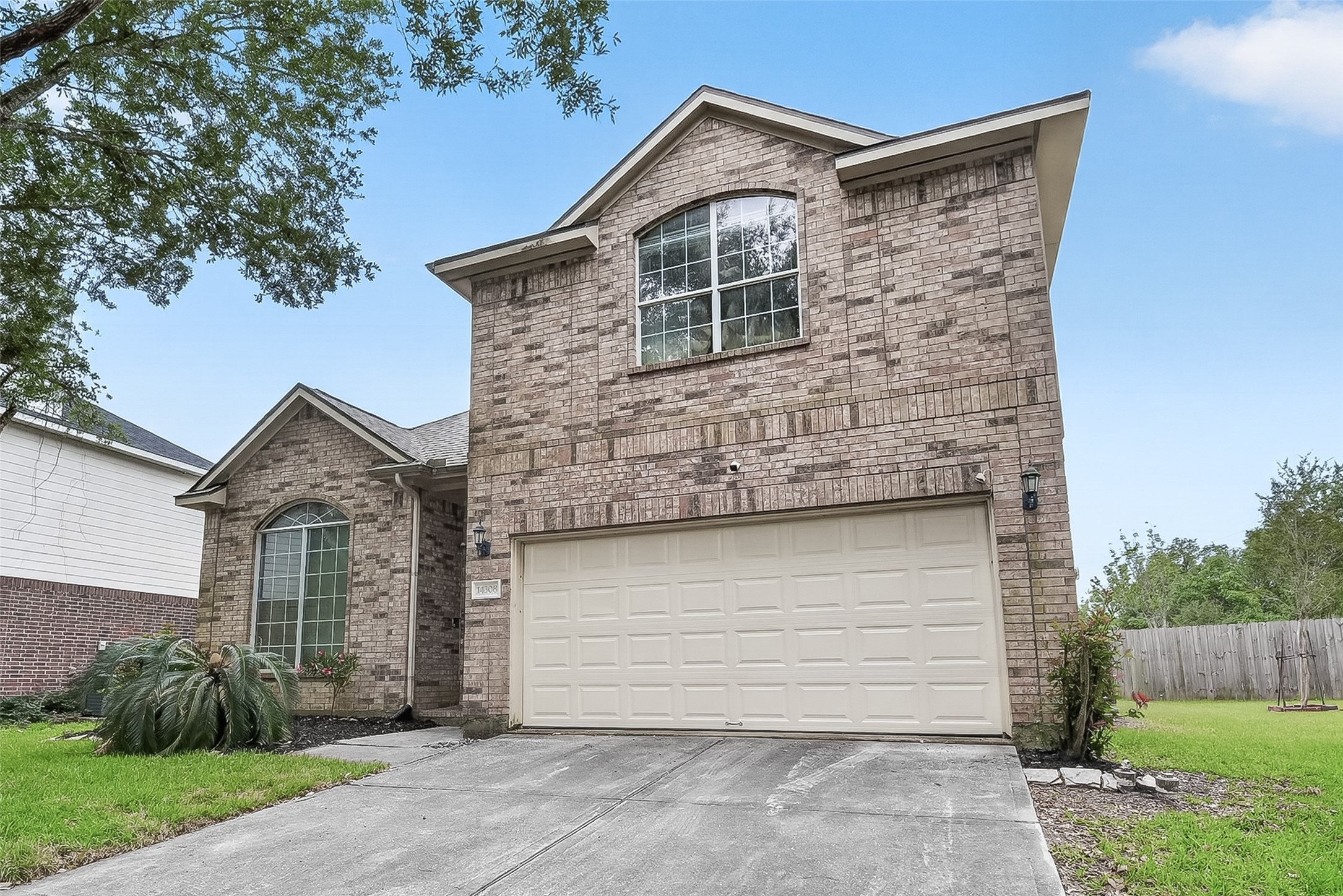 14308 Rocky Briar Lane Rosharon, TX 77583 - Photo 2 of 46 a front view of a house with a garden