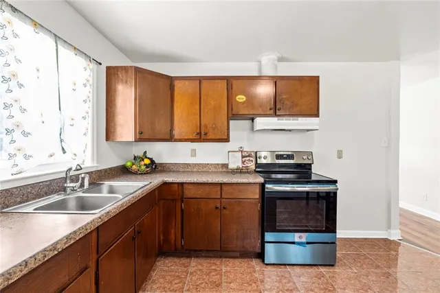 a kitchen with a sink stove and microwave