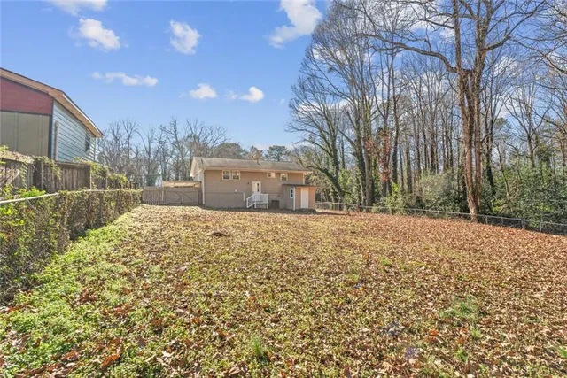 a view of a grey house with a yard