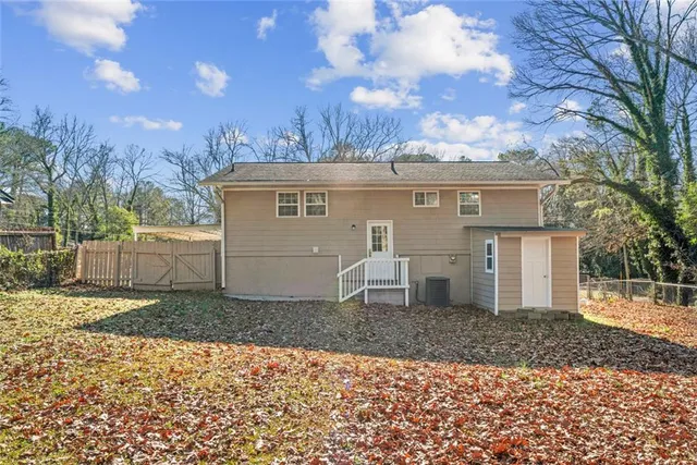 an aerial view of a house with swimming pool and porch