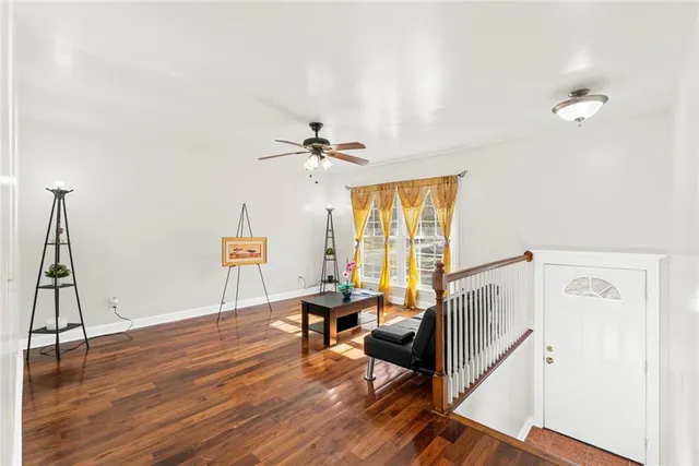 a view of a hallway with workspace and wooden floor