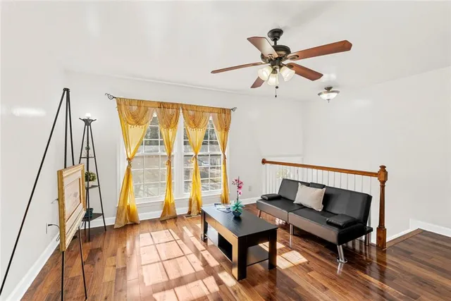 a living room with a bed furniture and a window
