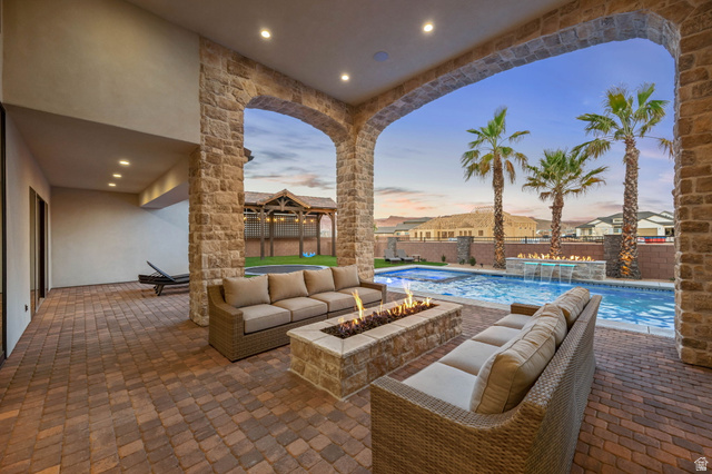 4871 South Homestead Way Washington, UT 84780 - Photo 108 of 151 Fenced backyard with a patio area and an outdoor living space with a fire pit