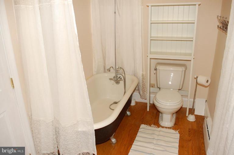 8448 Mercer Road Baldwin, MD 21013 - Photo 5 of 17 a bathroom with a toilet and a shower curtain