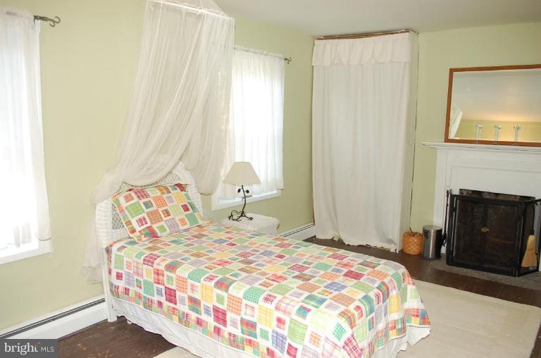 8448 Mercer Road Baldwin, MD 21013 - Photo 6 of 17 a bedroom with a bed and a fireplace