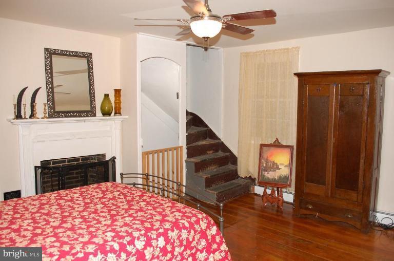 8448 Mercer Road Baldwin, MD 21013 - Photo 7 of 17 a bedroom with a bed and a fireplace