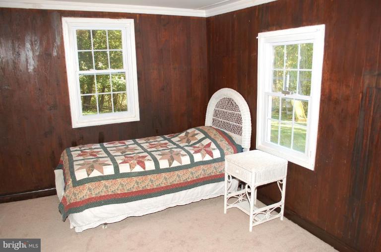 8448 Mercer Road Baldwin, MD 21013 - Photo 8 of 17 a bedroom with a bed chair and window
