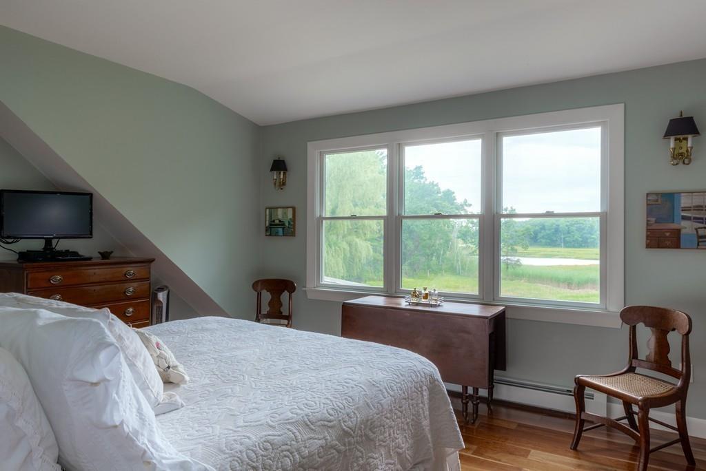 130 Argilla Road Ipswich, MA 01938 - Photo 26 of 42 a bedroom with a large bed and a flat tv screen on the dresser