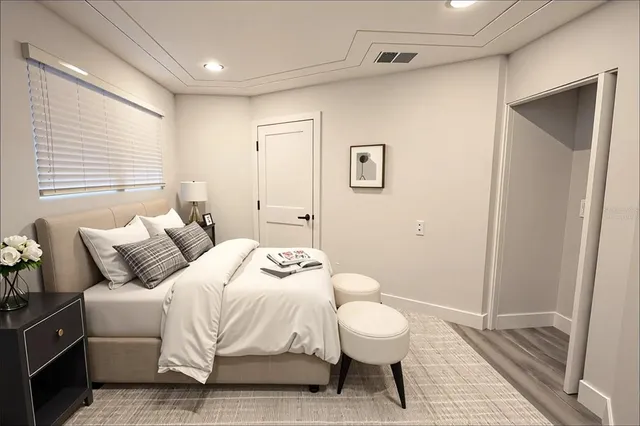 a bedroom with a bed and a couch
