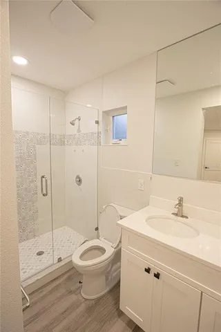 a bathroom with a sink a toilet and shower