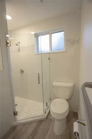 a bathroom with a toilet and a shower