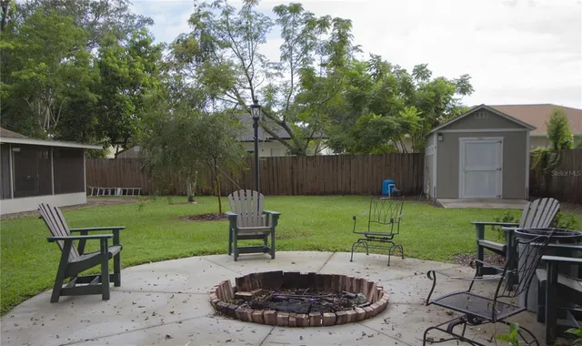 a view of a backyard with furniture and a backyard