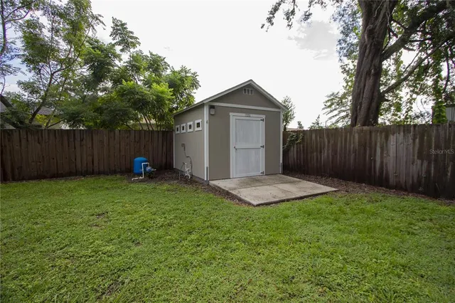 a view of backyard of house with green space