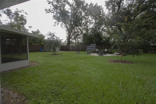 a view of a field of grass and trees