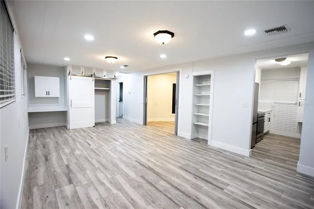 a view of a kitchen with a refrigerator and a window