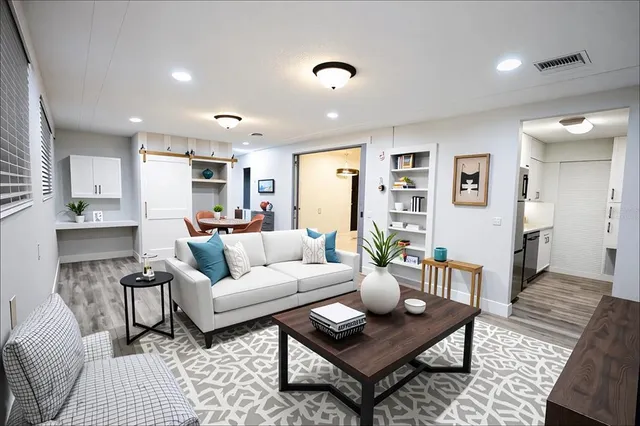 a living room with furniture and wooden floor