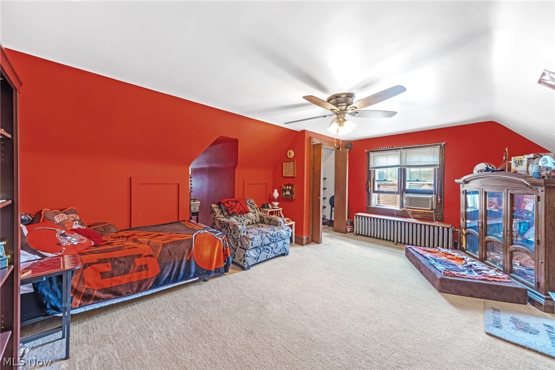 221 Raff Road Northwest Canton, OH 44708 - Photo 23 of 31 Sloped ceiling room featuring a ceiling fan, carpeted flooring, and a multi-pane window with blinds