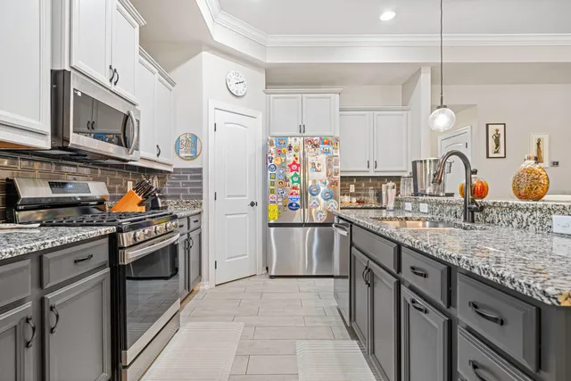 a kitchen with stainless steel appliances granite countertop a stove and a sink