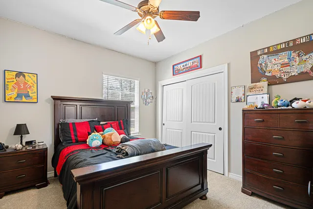 a bedroom with a bed and a chandelier