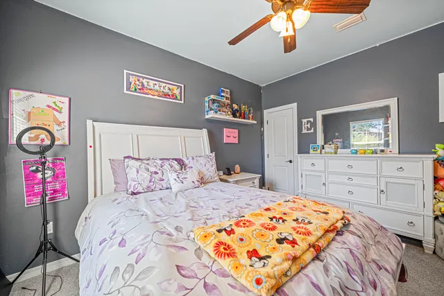 a bedroom with a bed and a dresser in it