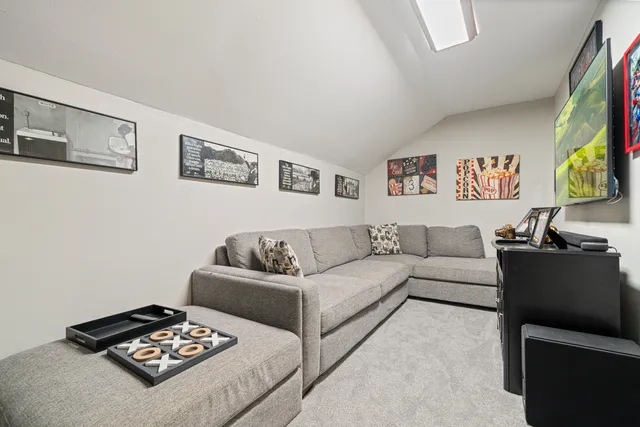 a living room with couches and a flat screen tv