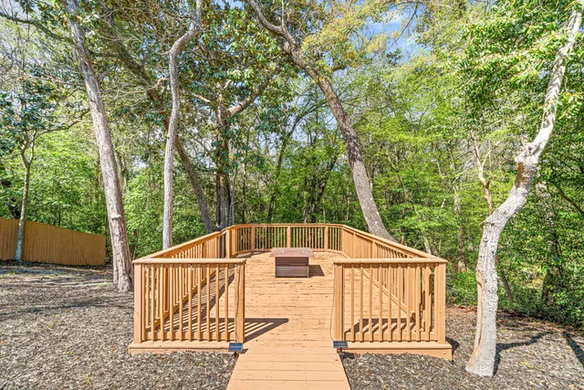 a white house that has a tree in front of it