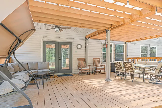 a view of a patio with table and chairs and wooden floor