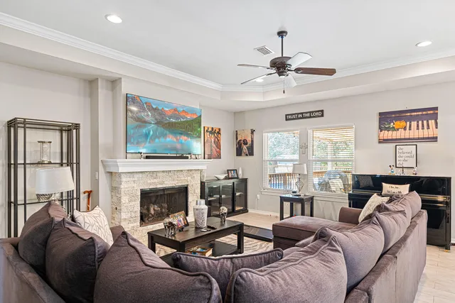 a living room with furniture a fireplace and a flat screen tv