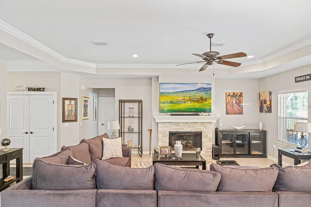 a living room with furniture a fireplace and a flat screen tv