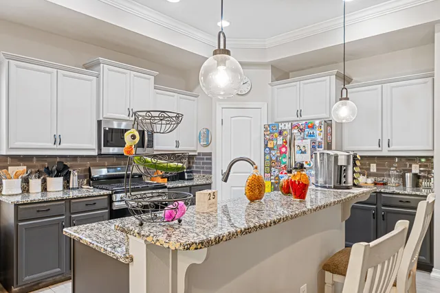 a kitchen with stainless steel appliances granite countertop a sink and cabinets