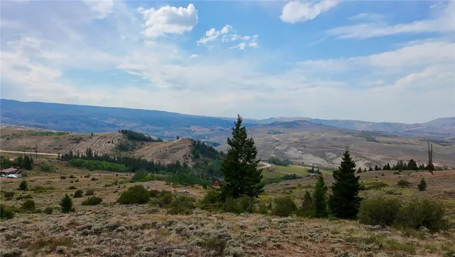 a view of a dry yard with mountains in the background