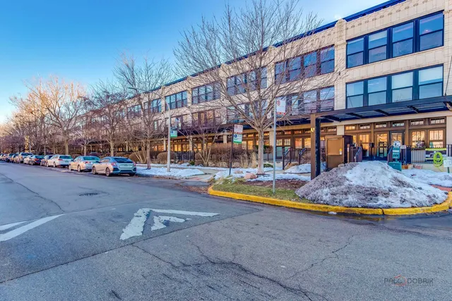 a view of a large swimming pool with an outdoor space and seating area