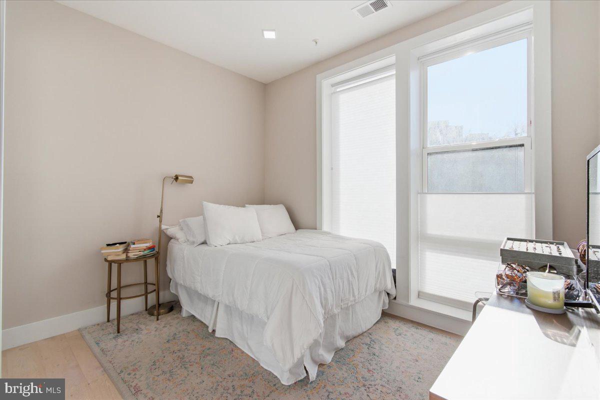 1028 Bladensburg Road Northeast, Unit 18 Washington, DC 20002 - Photo 11 of 22 a bedroom with a bed and a window