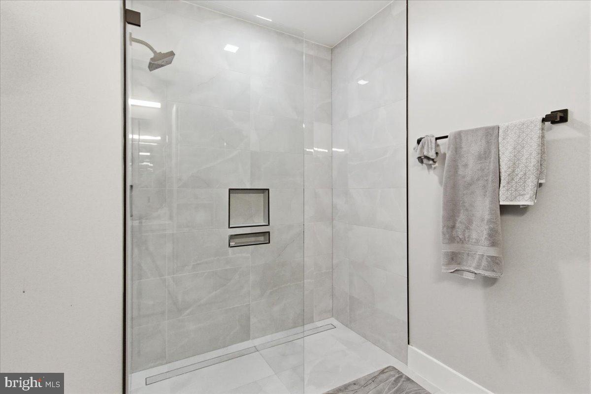 1028 Bladensburg Road Northeast, Unit 18 Washington, DC 20002 - Photo 13 of 22 a bathroom with a shower and a glass door