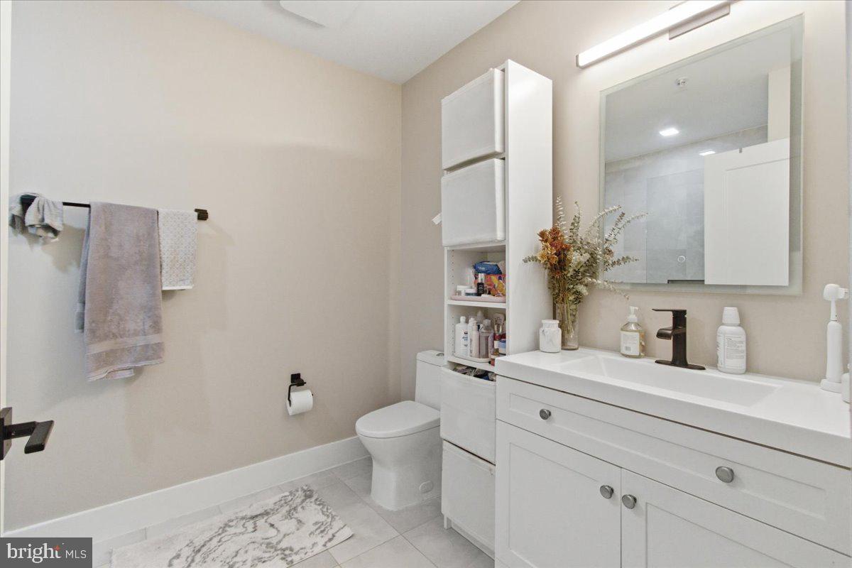 1028 Bladensburg Road Northeast, Unit 18 Washington, DC 20002 - Photo 14 of 22 a bathroom with a sink a toilet and a mirror