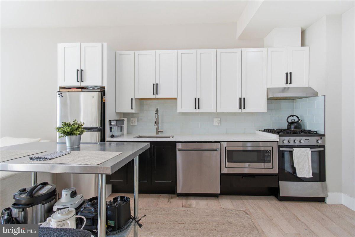 1028 Bladensburg Road Northeast, Unit 18 Washington, DC 20002 - Photo 8 of 22 a kitchen with stainless steel appliances a sink and stove