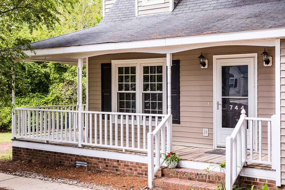 Charming front porch that wraps around to the side of the home. Perfect for rocking chairs and that tall lemonade. Exterior Front
