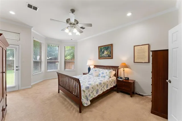 a bedroom with a bed chandelier and a window