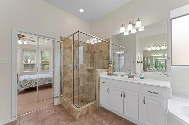 a bathroom with a shower sink and mirror