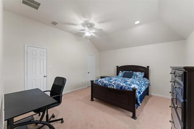a bedroom with a bed and a desk