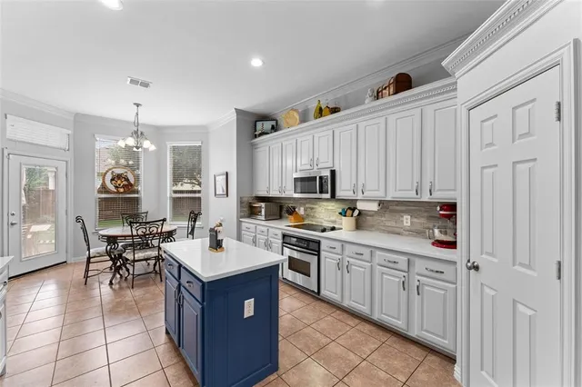a kitchen with stainless steel appliances granite countertop a stove top oven a sink a counter top space and cabinets