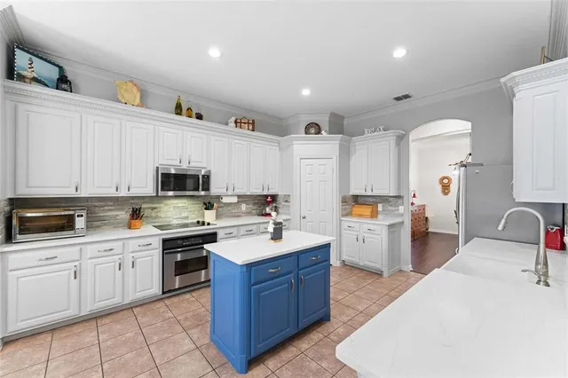 a kitchen with a sink stove and cabinets