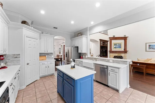 a kitchen with a sink stove and cabinets